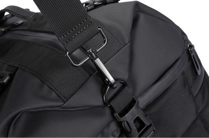 Close-up of a black backpack with a strap and buckle on a white background